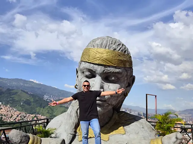 Sculpture at a Comuna 13 viewpoint with the Medellín valley behind