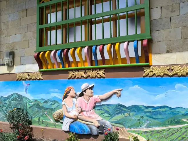 Hand-painted zócalo on a house front in Guatapé